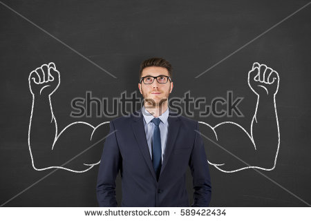 Businessman in front of chalkboard with muscular arms drawn in