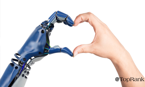 Robot and human hands forming a heart image.